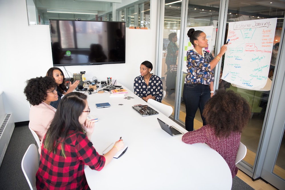 A group of people having a meeting in an conference room.